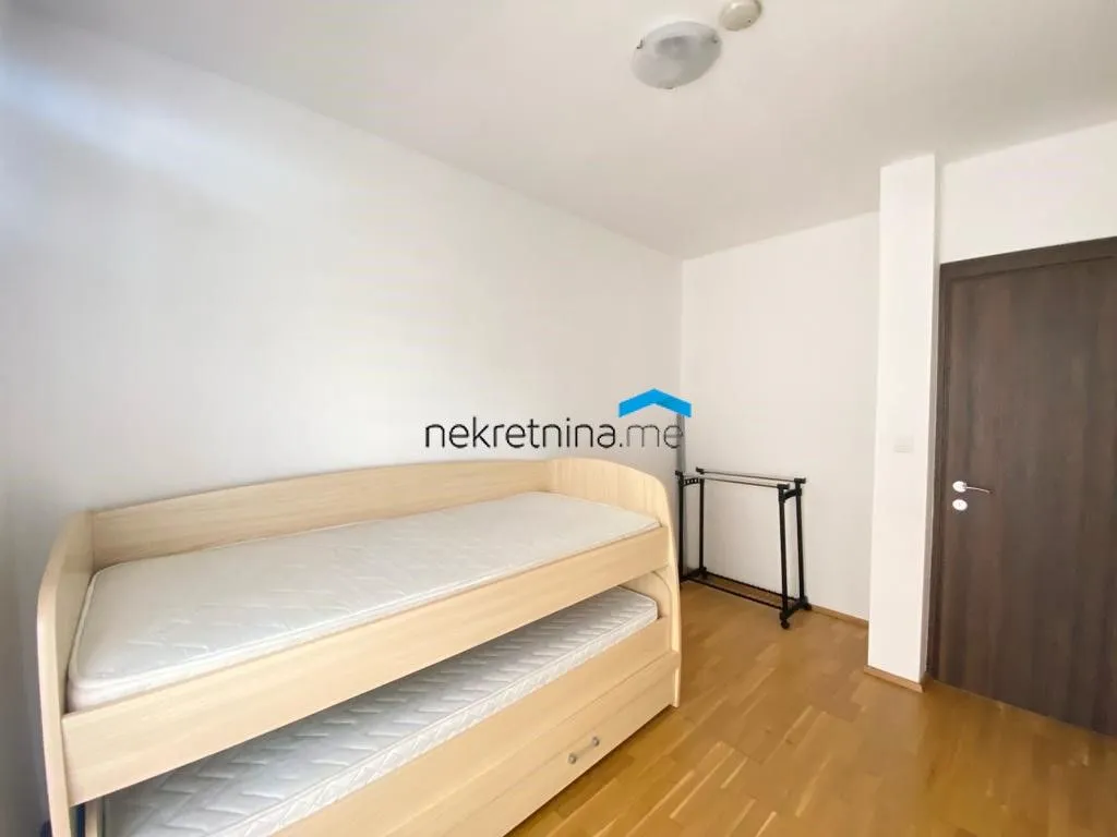 Small bedroom with a bunk bed and wooden flooring.