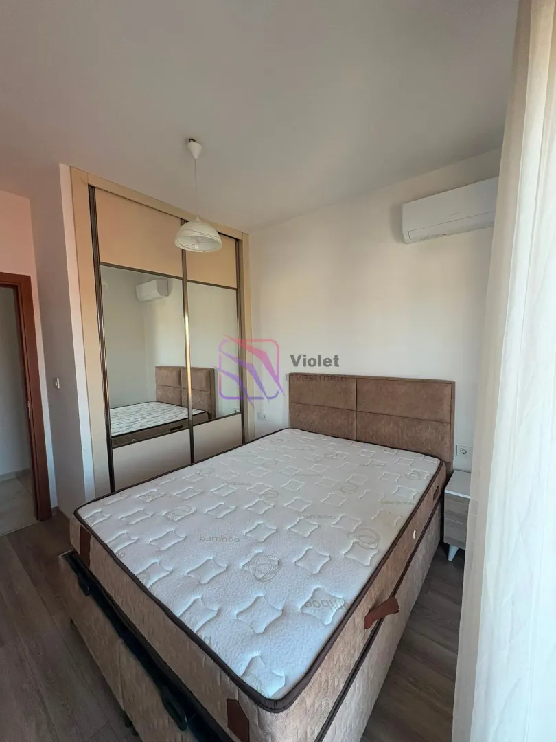 Bedroom with a double bed and a built-in wardrobe with a mirror.