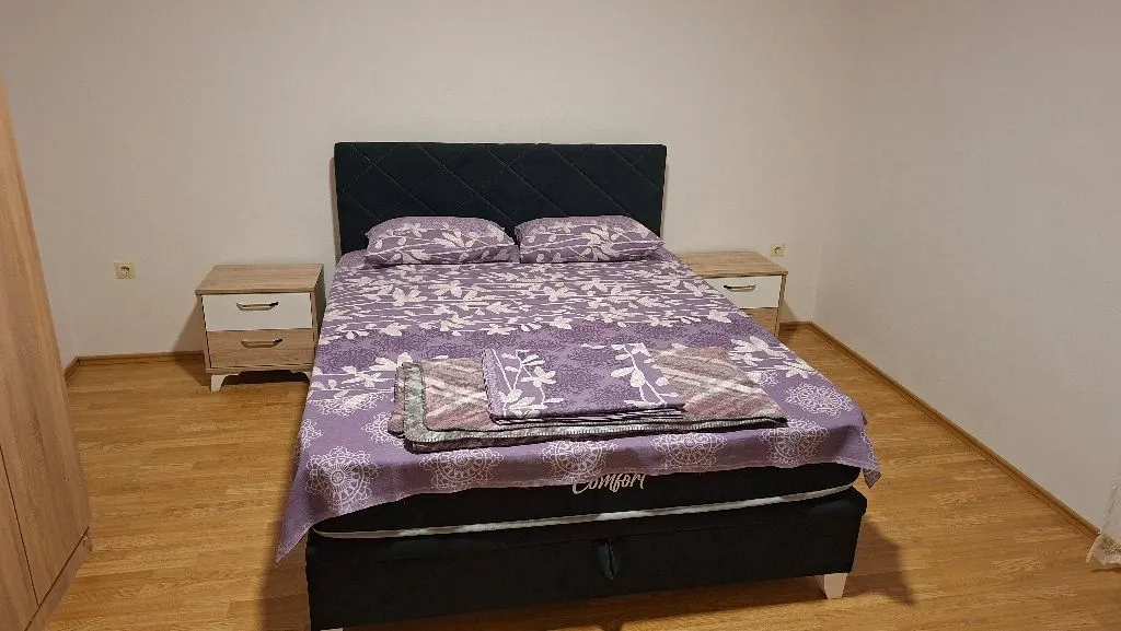 Furnished bedroom with a double bed and nightstands.