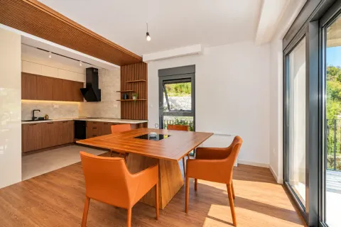 Modern kitchen with a dining area and wooden elements. - image 12
