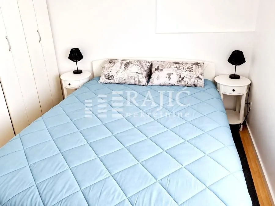 Furnished bedroom with a double bed and nightstands.
