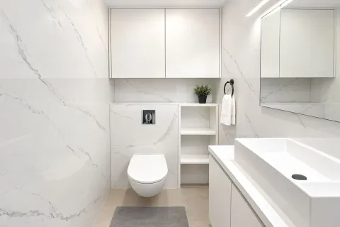 Modernly equipped bathroom with white ceramic tiles and built-in sanitaryware. - image 16