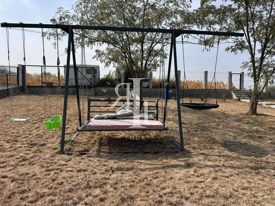 Yard with swings and play equipment.