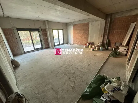 Interior of an unfinished apartment in rough construction with building materials. - image 5