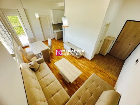 Living room with dining area and kitchen in the background. - image 3