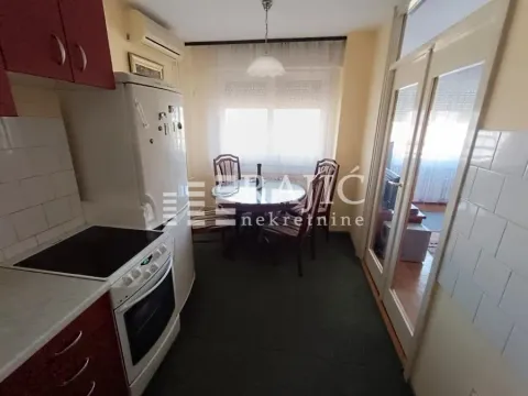 Small kitchen with a dining area and appliances. - image 5