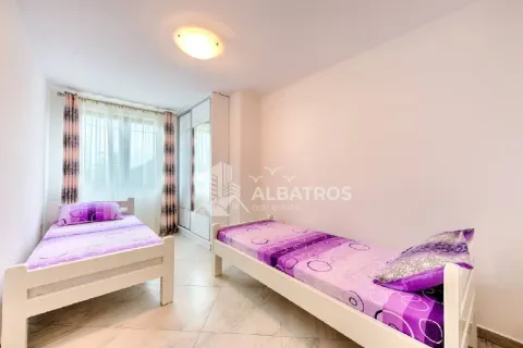 Bedroom with two single beds and a wardrobe. - image 8
