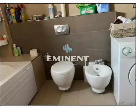 Bathroom equipped with sanitary fixtures, a bathtub, and a washing machine. - image 11