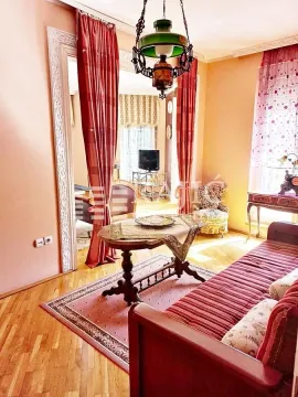 Living room with sofa, rug, and traditional furniture. - image 7