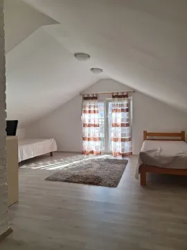 Attic bedroom furnished with two beds and access to a terrace. - image 10