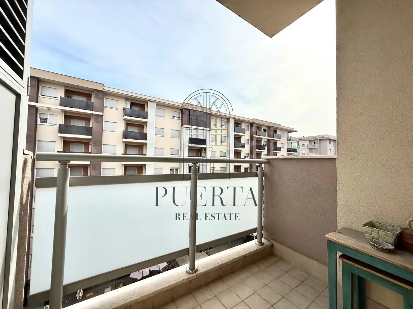 Balcony with a view of surrounding residential buildings.