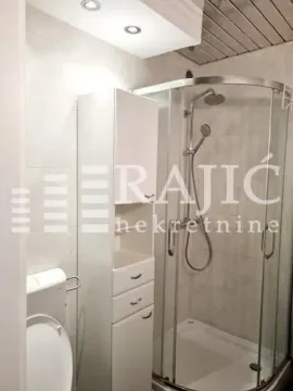 Smaller bathroom with a shower cabin and white furniture. - image 5