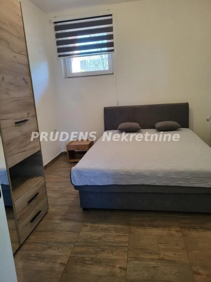 Furnished bedroom with a double bed and wardrobe.