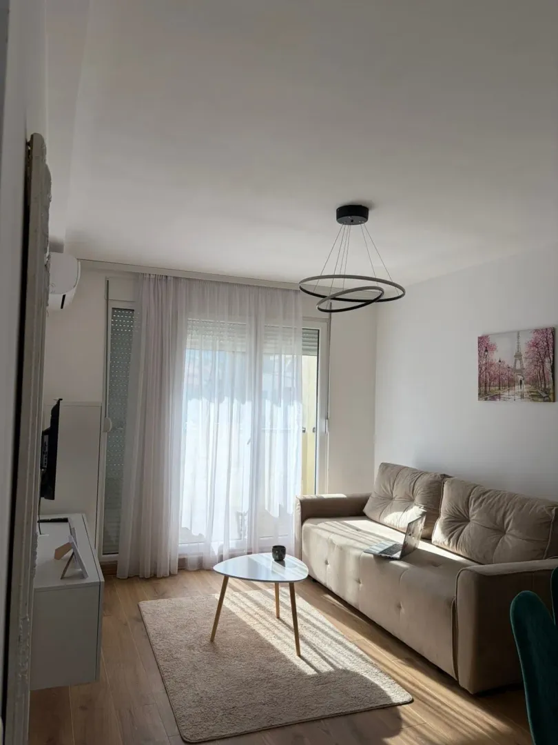 Bright and tidy living room with a sofa and coffee table.