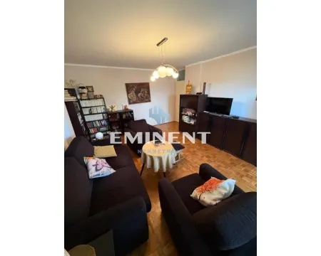Living room with seating furniture, bookshelves, and a television. - image 4