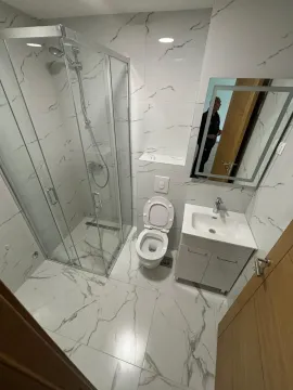 Moderno opremljeno kupatilo sa tuš kabinom i mermernim pločicama. - image 5