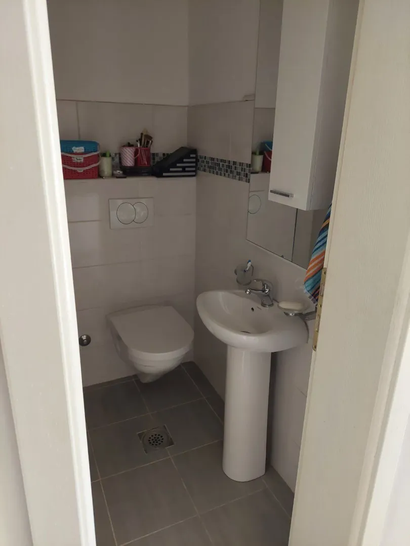 Small bathroom with a pedestal sink and toilet.
