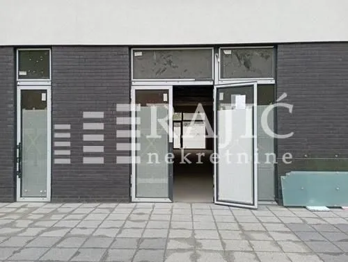 Exterior view of a commercial space with glass entrance doors.