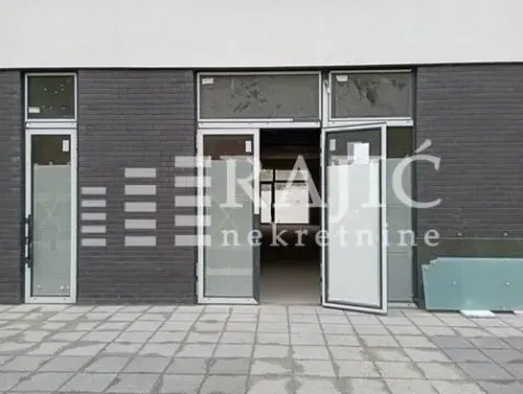 Exterior view of a commercial space with glass entrance doors. - image 4