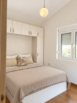 A furnished bedroom with a double bed and built-in closets. - image 5