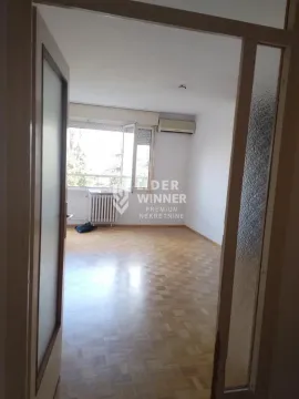 View from the hallway into an empty room with parquet flooring and an air conditioning unit. - image 14