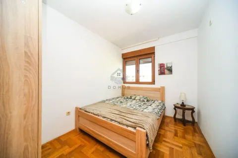 Furnished bedroom with a double bed and wooden flooring. - image 11