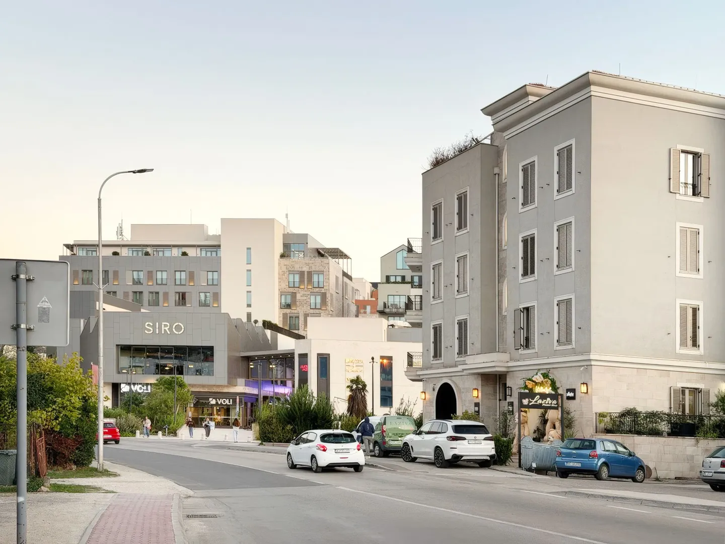 View of the street and modern residential and commercial buildings.