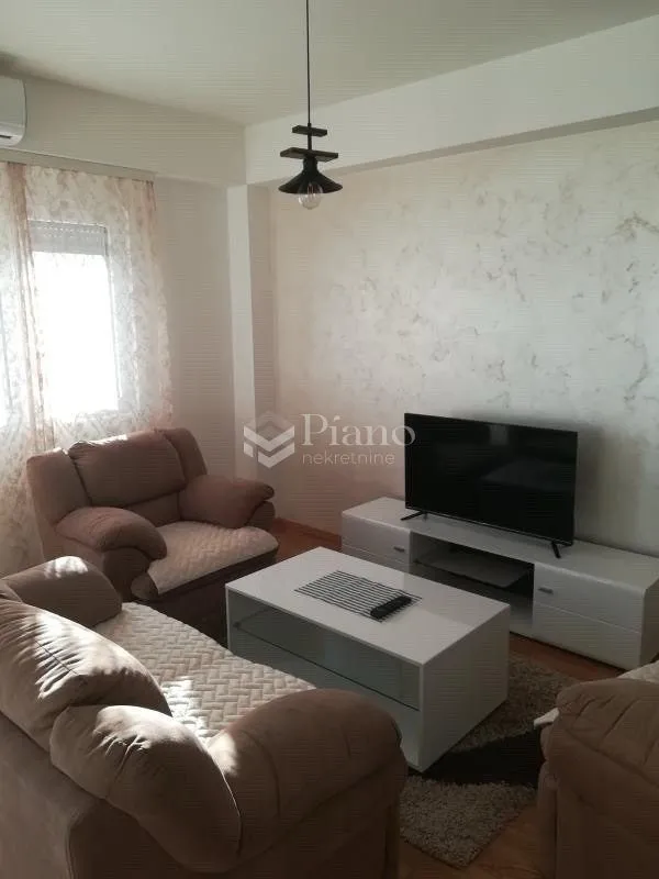 Living room with a sofa set, television, and coffee table.