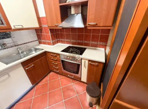 Kitchen equipped with wooden cabinetry, a sink, and a built-in oven. - image 6