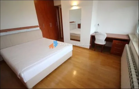 Furnished bedroom with a double bed, wardrobe, and a desk. - image 21