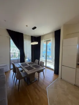 Living room with dining area and access to a terrace with a sea view. - image 4
