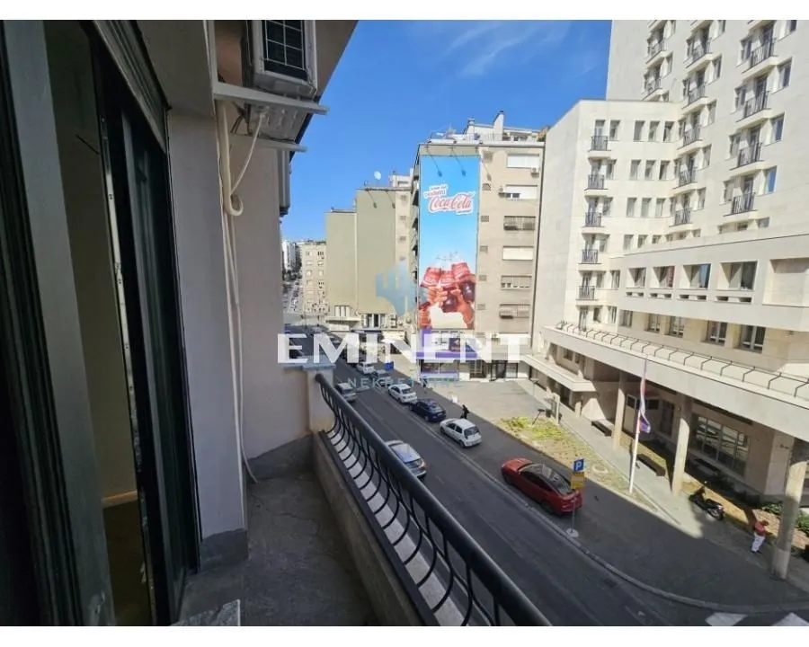 View from the balcony overlooking the city street and surrounding buildings.