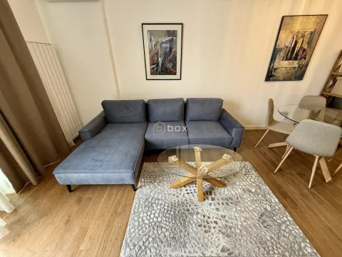 Living room with a grey corner sofa and a dining table. - image 4