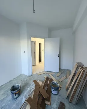 Room under construction with building materials on the floor. - image 10