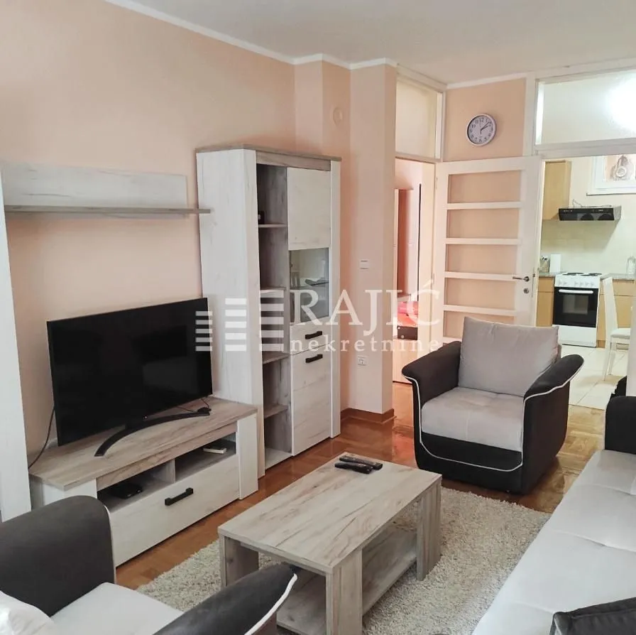 Furnished living room with a sofa set and TV unit.
