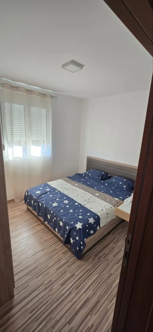 Furnished bedroom with a double bed.