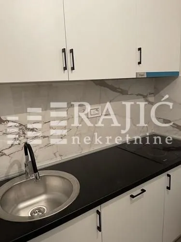 Modern kitchen with a sink, countertop, and built-in units.