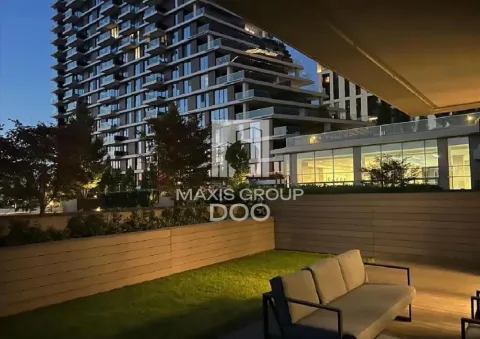 Furnished terrace with seating furniture and a view of the building at dusk. - image 18