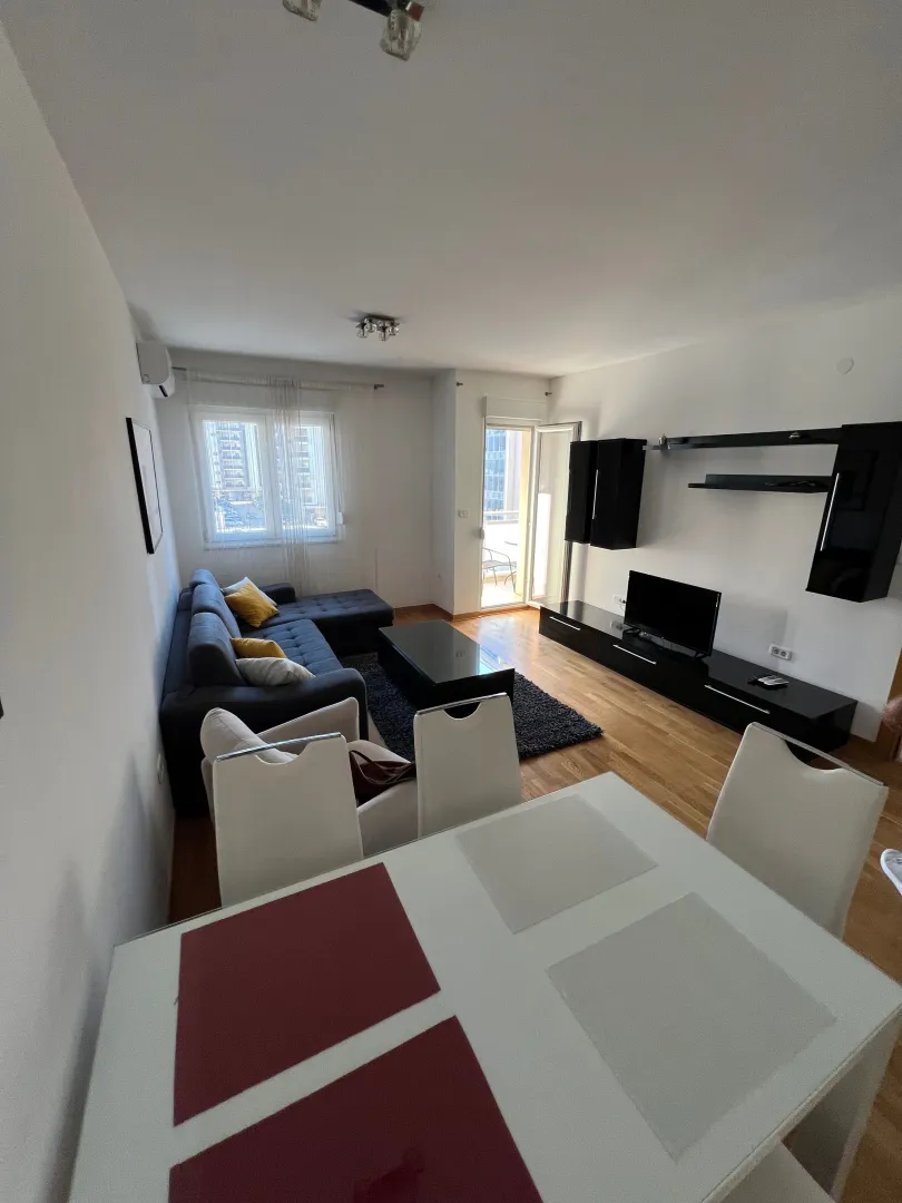 Spacious living room with a sofa set and a dining table.