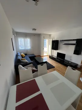 Spacious living room with a sofa set and a dining table. - image 12