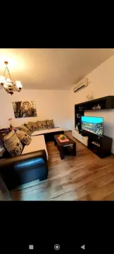 Living room with a sofa set, TV unit, and dining table. - image 2