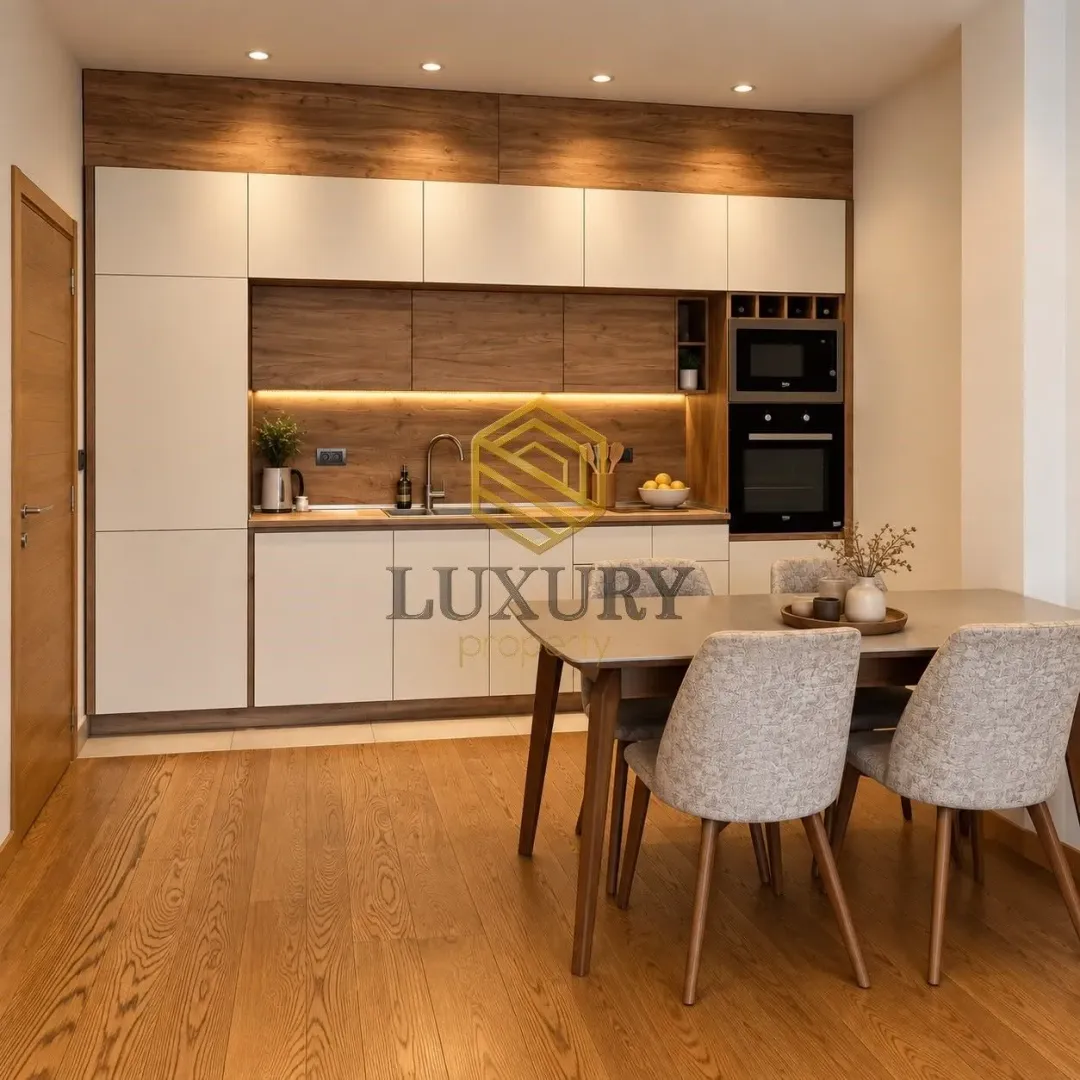 Modern kitchen with dining area and built-in appliances.