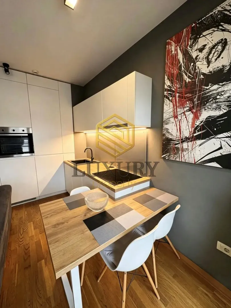 Modern kitchen with a dining table and built-in appliances.