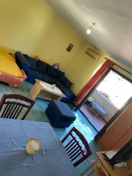 Living room with a sofa set and a dining area. - image 2