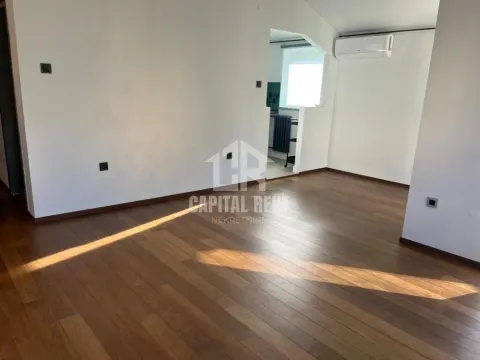 Empty living room with wooden flooring and an air conditioner. - image 17