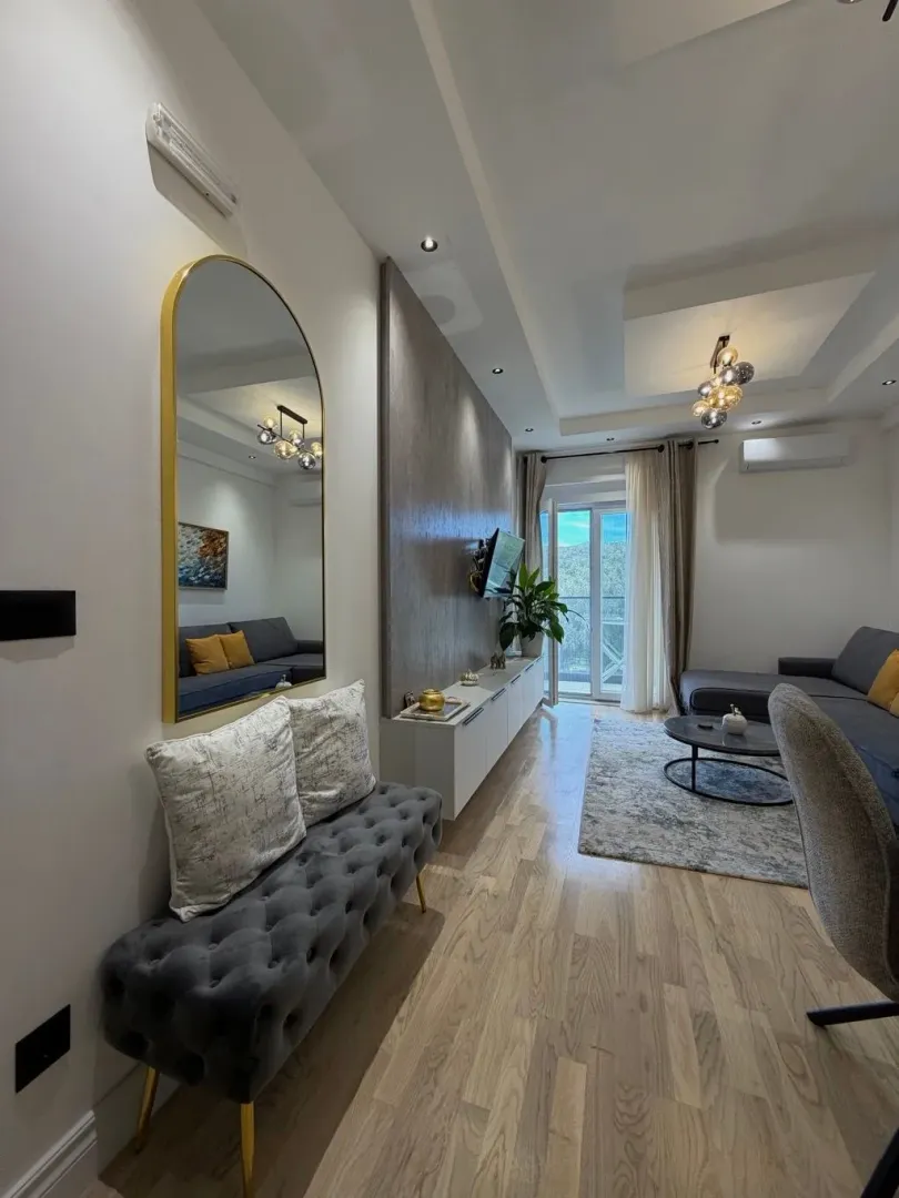 Modern and bright living room with a sofa and decorative details.