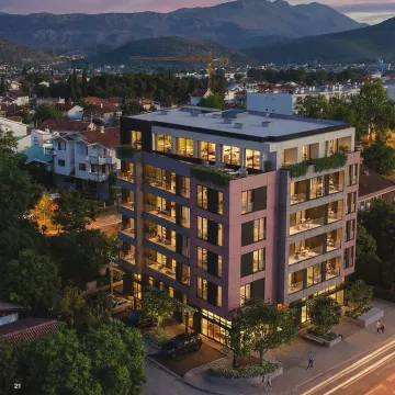 Aerial view of a modern residential building with illuminated terraces at dusk. - image 4