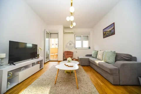 Comfortable living room with a sectional sofa, TV, and access to the terrace. - image 2