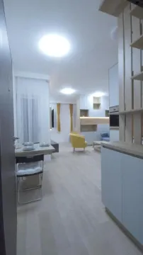 View of the living room and dining area with furniture and a wooden partition element. - image 8