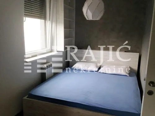 Smaller bedroom with a double bed and a window.